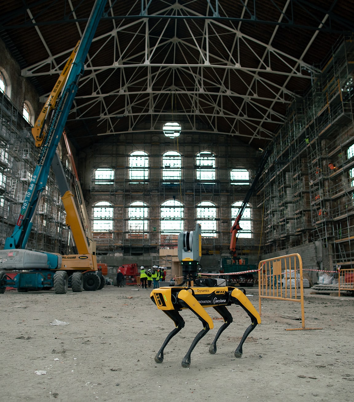 Spot with a laser scanner in front of a crane