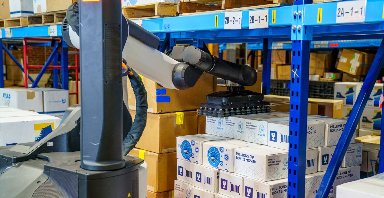 Robot reaching industrial arm under racking