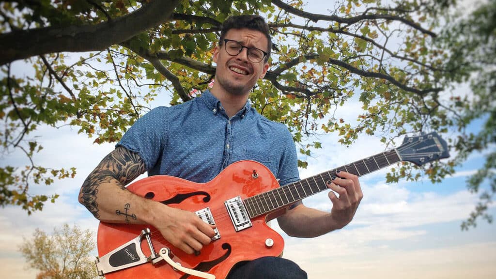  Jonathon Streker plays guitar outside