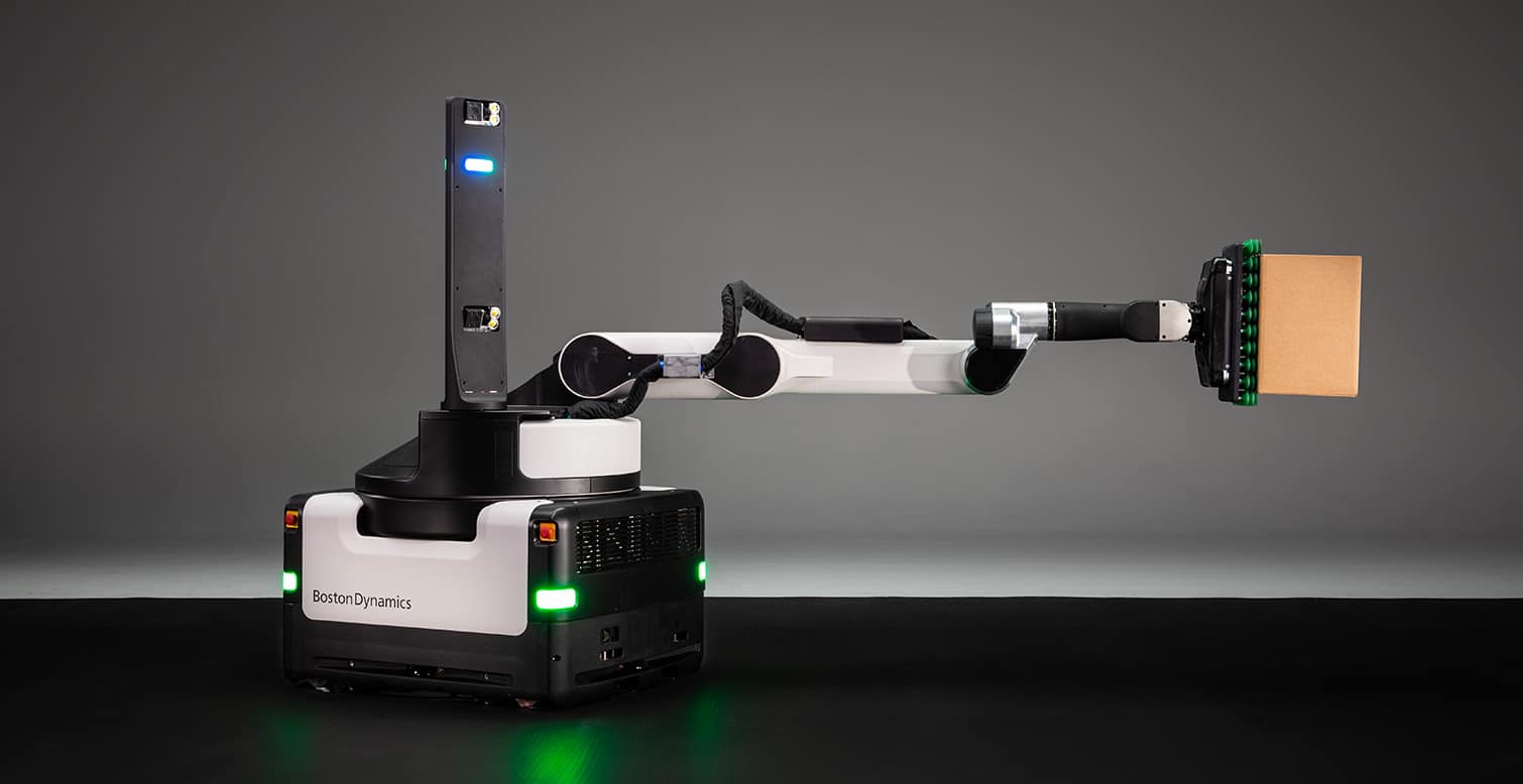 Stretch robot with arm fully extended holding a box